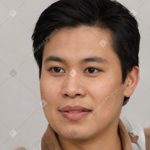 Joyful asian young-adult male with short  brown hair and brown eyes