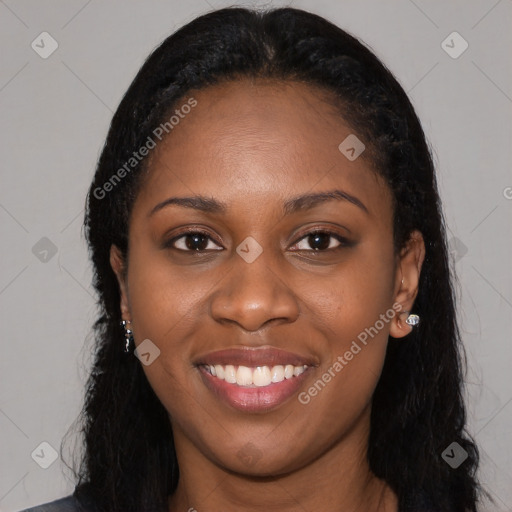 Joyful black young-adult female with long  black hair and brown eyes