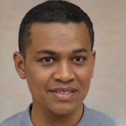 Joyful black young-adult male with short  brown hair and brown eyes