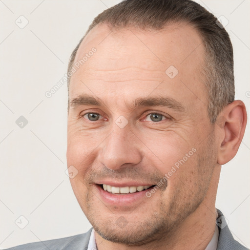 Joyful white adult male with short  brown hair and brown eyes