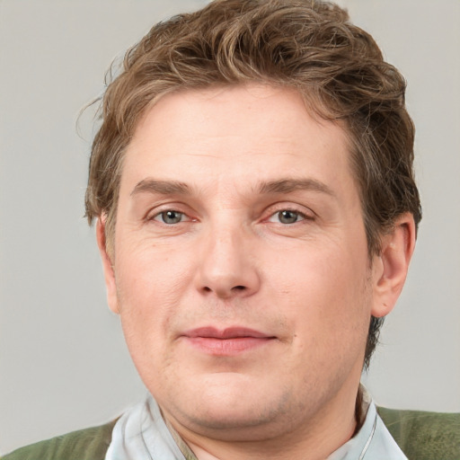 Joyful white adult male with short  brown hair and grey eyes