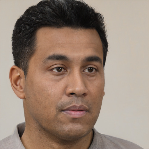 Neutral latino young-adult male with short  black hair and brown eyes