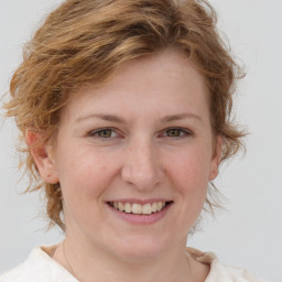 Joyful white young-adult female with medium  brown hair and blue eyes