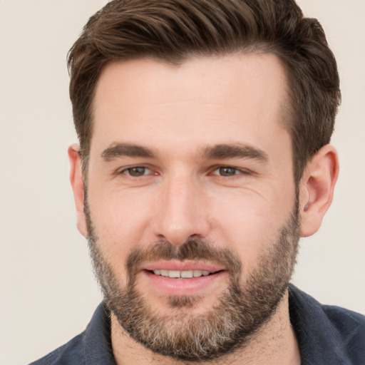 Joyful white young-adult male with short  brown hair and brown eyes