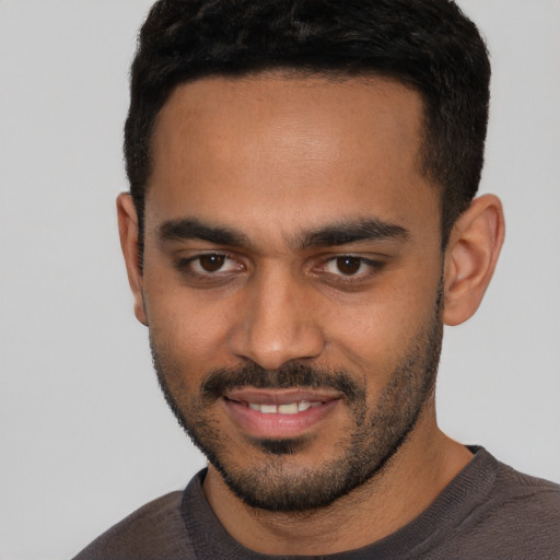 Joyful latino young-adult male with short  black hair and brown eyes