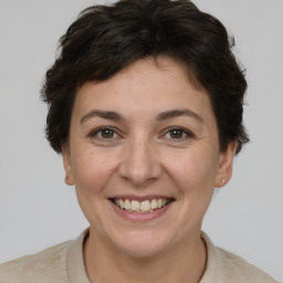 Joyful white adult female with short  brown hair and brown eyes