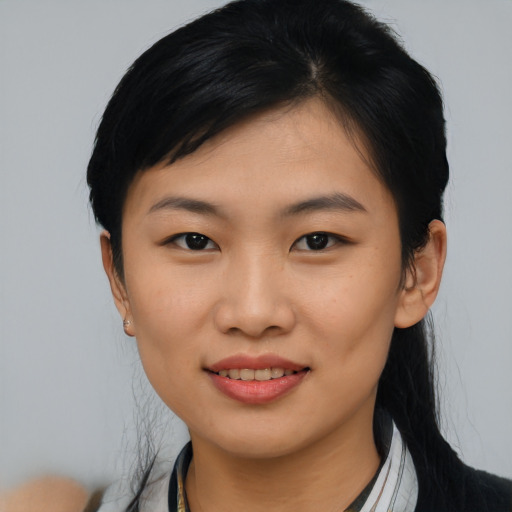 Joyful asian young-adult female with short  black hair and brown eyes