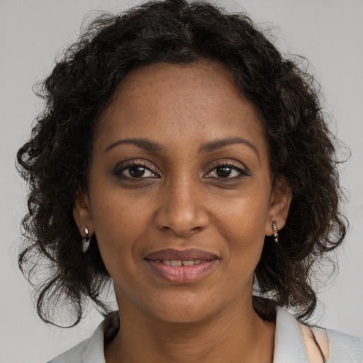 Joyful black young-adult female with medium  brown hair and brown eyes