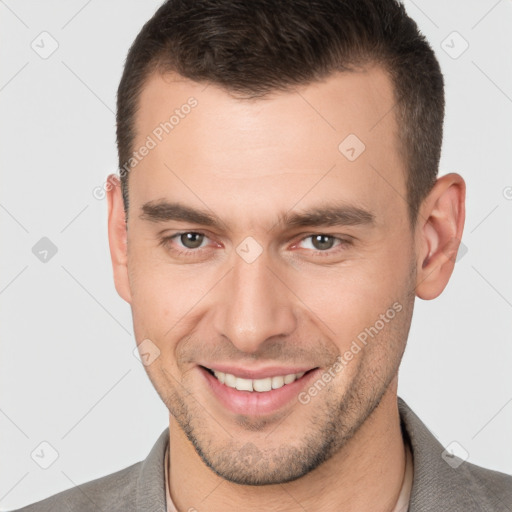 Joyful white young-adult male with short  brown hair and brown eyes