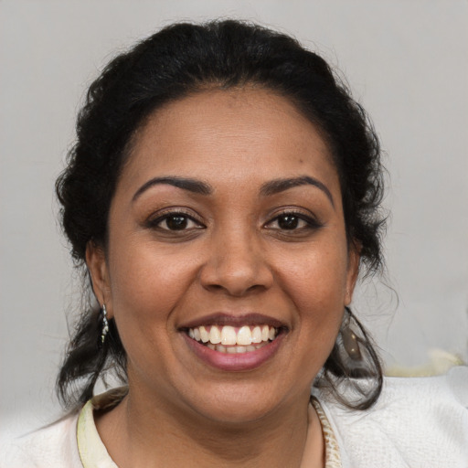Joyful black young-adult female with medium  brown hair and brown eyes