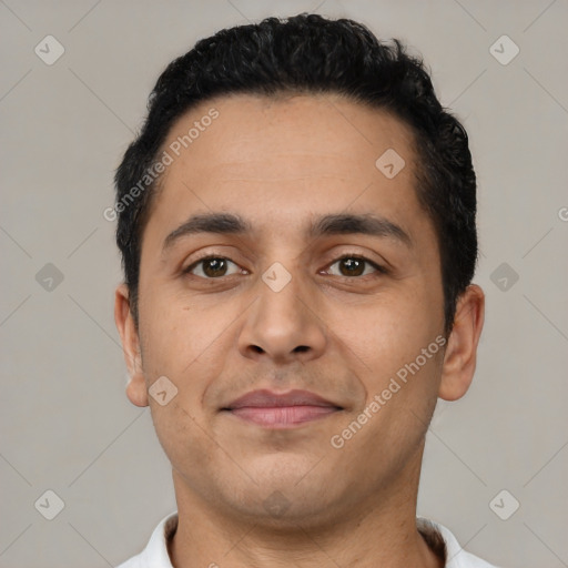 Joyful latino young-adult male with short  black hair and brown eyes