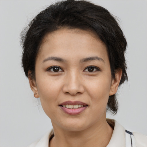 Joyful asian young-adult female with short  brown hair and brown eyes