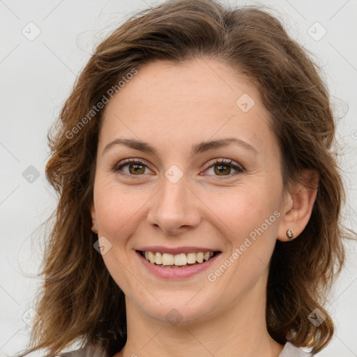 Joyful white young-adult female with long  brown hair and green eyes