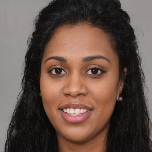 Joyful latino young-adult female with long  black hair and brown eyes