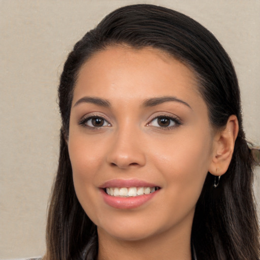 Joyful white young-adult female with long  brown hair and brown eyes