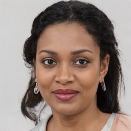 Joyful black young-adult female with medium  brown hair and brown eyes