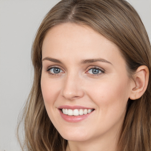 Joyful white young-adult female with long  brown hair and grey eyes