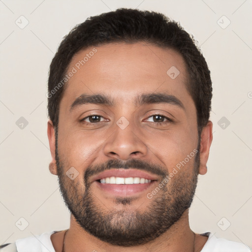 Joyful white young-adult male with short  black hair and brown eyes