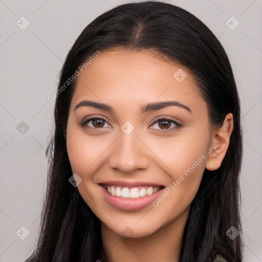 Joyful latino young-adult female with long  brown hair and brown eyes