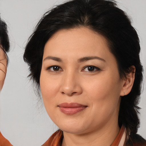 Joyful asian adult female with medium  brown hair and brown eyes