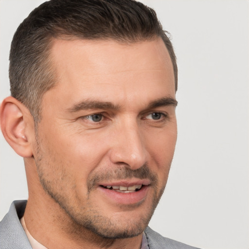 Joyful white adult male with short  brown hair and brown eyes