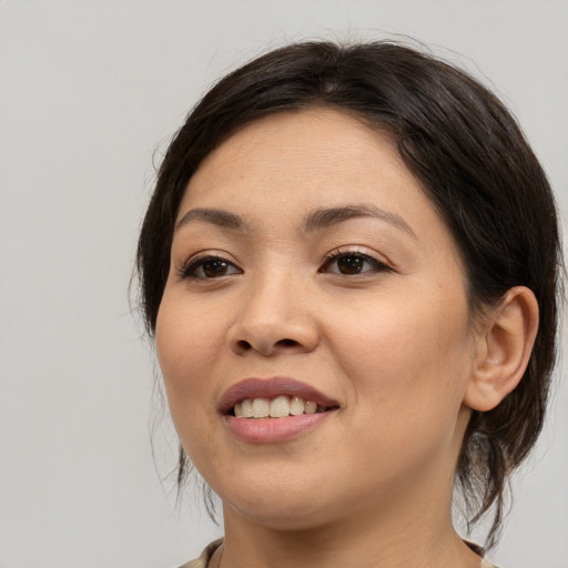 Joyful asian young-adult female with medium  brown hair and brown eyes