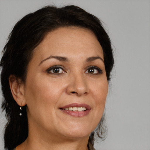 Joyful white adult female with medium  brown hair and brown eyes