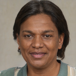 Joyful black adult female with medium  brown hair and brown eyes