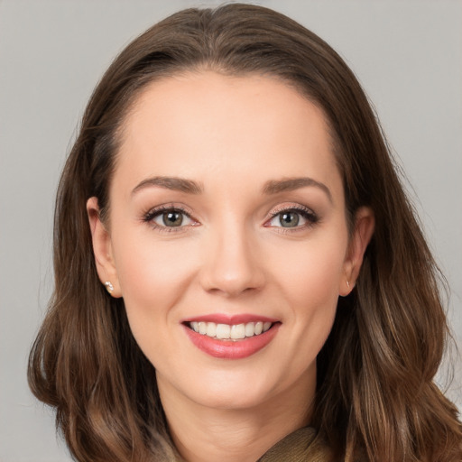 Joyful white young-adult female with long  brown hair and grey eyes