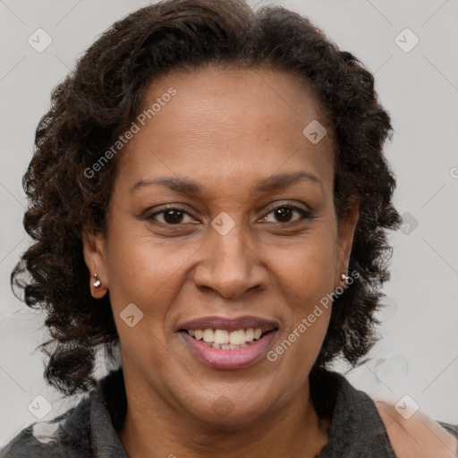 Joyful black adult female with medium  brown hair and brown eyes