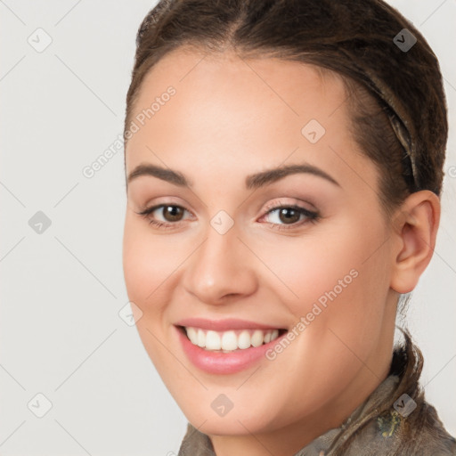 Joyful white young-adult female with long  brown hair and brown eyes