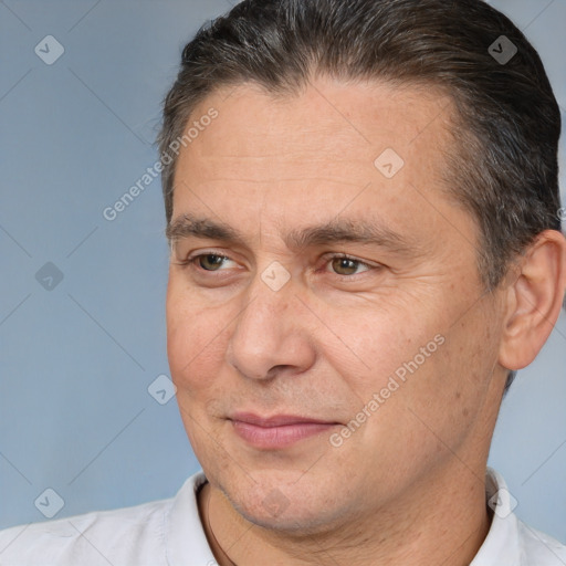 Joyful white adult male with short  brown hair and brown eyes