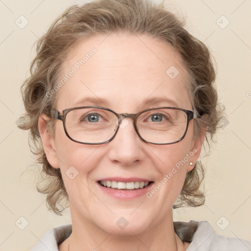 Joyful white adult female with medium  brown hair and blue eyes