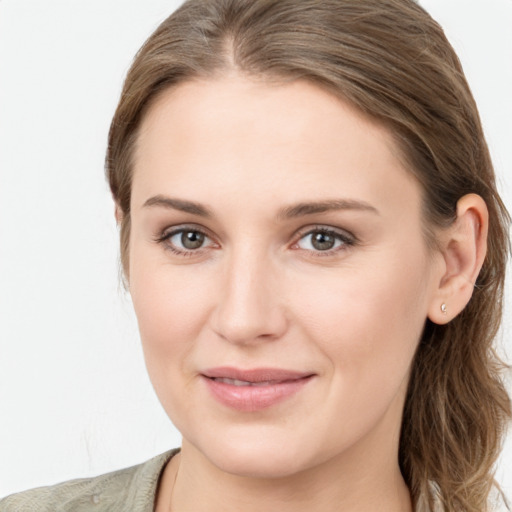 Joyful white young-adult female with long  brown hair and grey eyes