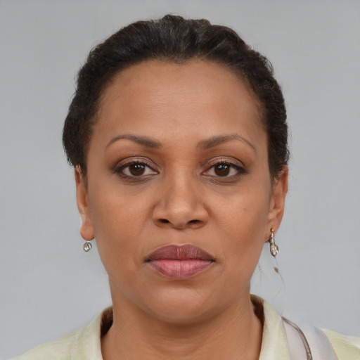 Joyful latino adult female with short  brown hair and brown eyes