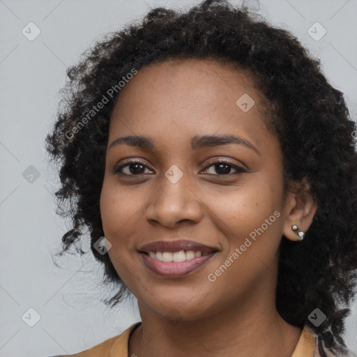 Joyful black young-adult female with long  black hair and brown eyes