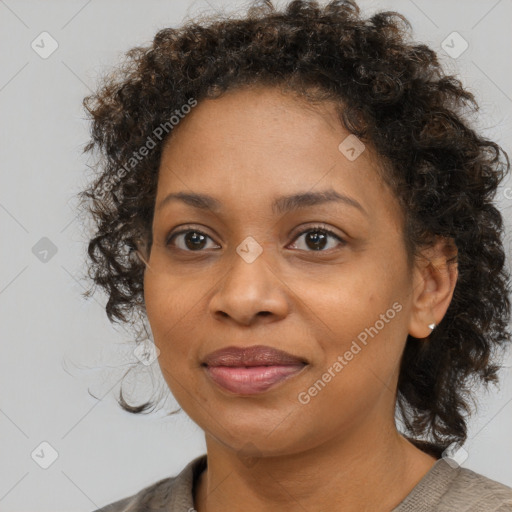 Joyful black young-adult female with medium  brown hair and brown eyes