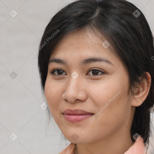Joyful latino young-adult female with medium  brown hair and brown eyes