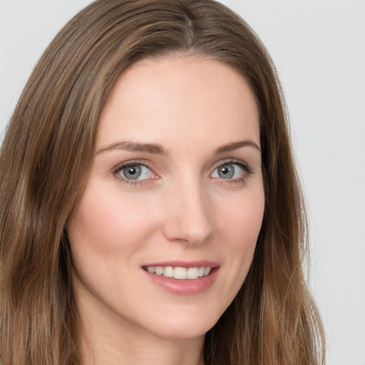 Joyful white young-adult female with long  brown hair and green eyes