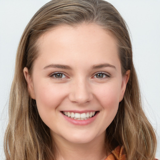 Joyful white young-adult female with long  brown hair and grey eyes