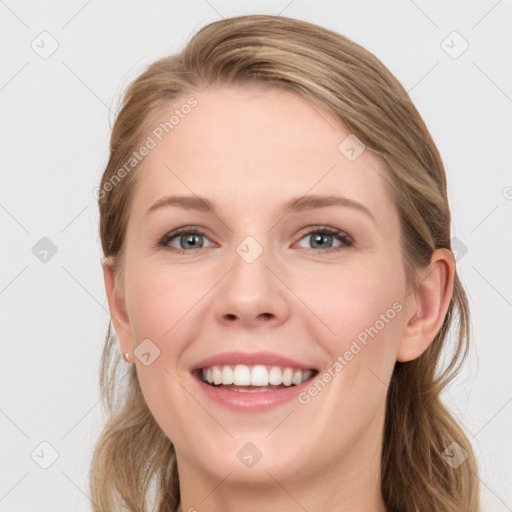 Joyful white young-adult female with long  brown hair and blue eyes