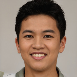 Joyful asian young-adult male with short  brown hair and brown eyes