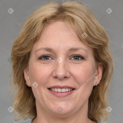 Joyful white adult female with medium  brown hair and grey eyes