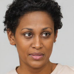 Joyful black adult female with short  brown hair and brown eyes