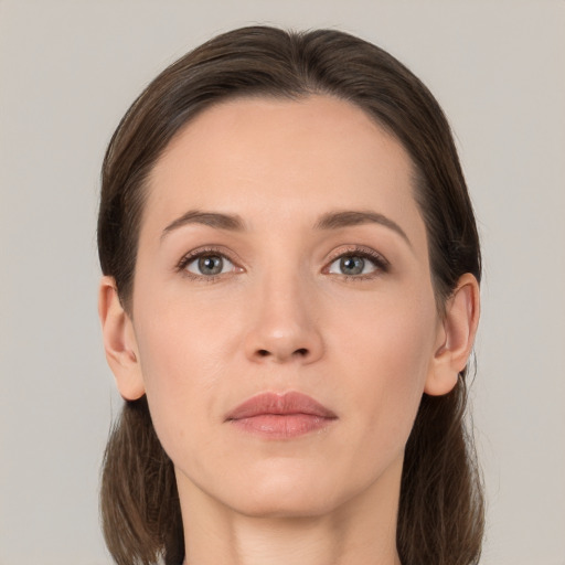 Joyful white young-adult female with long  brown hair and grey eyes