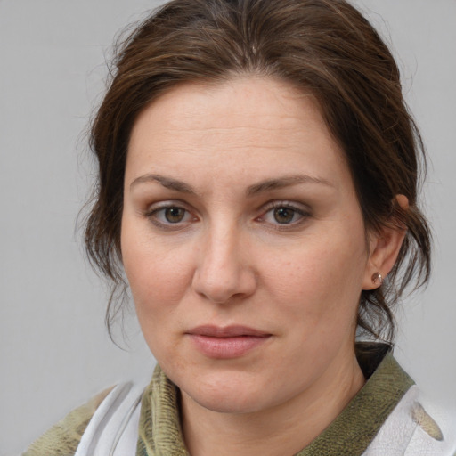 Joyful white adult female with medium  brown hair and grey eyes