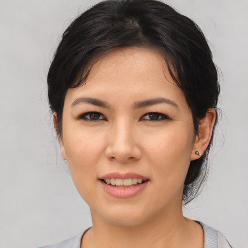 Joyful asian young-adult female with medium  black hair and brown eyes