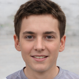 Joyful white child male with short  brown hair and brown eyes