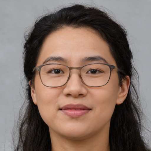 Joyful white adult female with long  brown hair and brown eyes