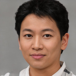 Joyful asian young-adult male with short  brown hair and brown eyes